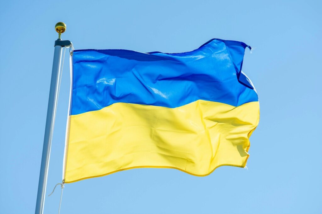a blue and yellow flag flying in the wind